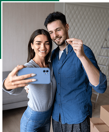 Happy couple taking selfie in their new home