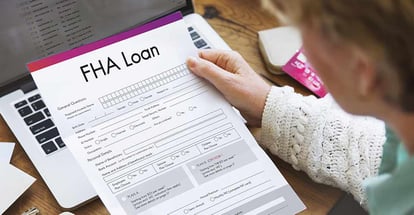 A Person Looking at FHA Loan Application Form