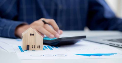 A buyer calculating a cost to buy a new house