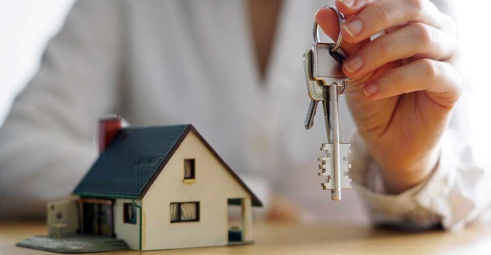 A closeup shot of a person holding a new house key