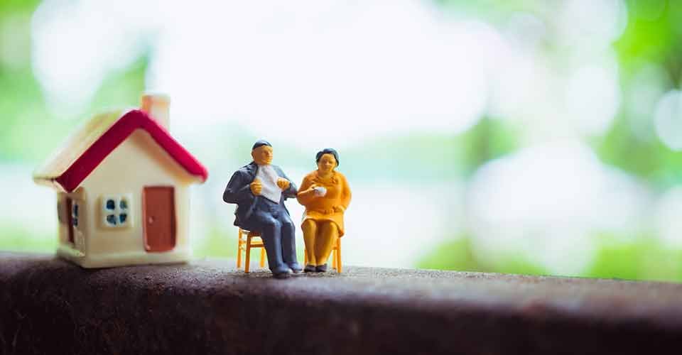 A couple outside their home