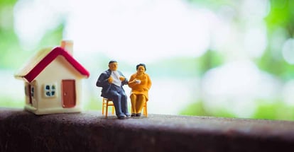 A couple outside their home