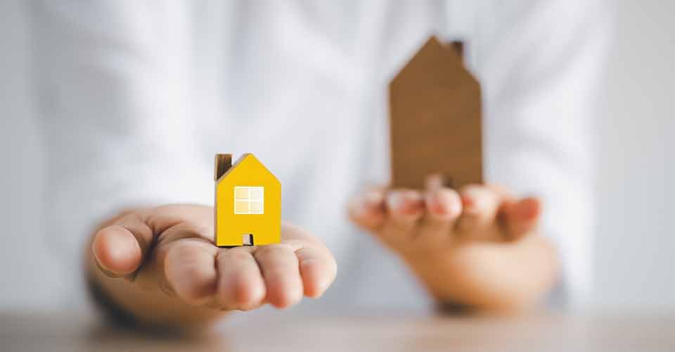 A hand chooses a new home model