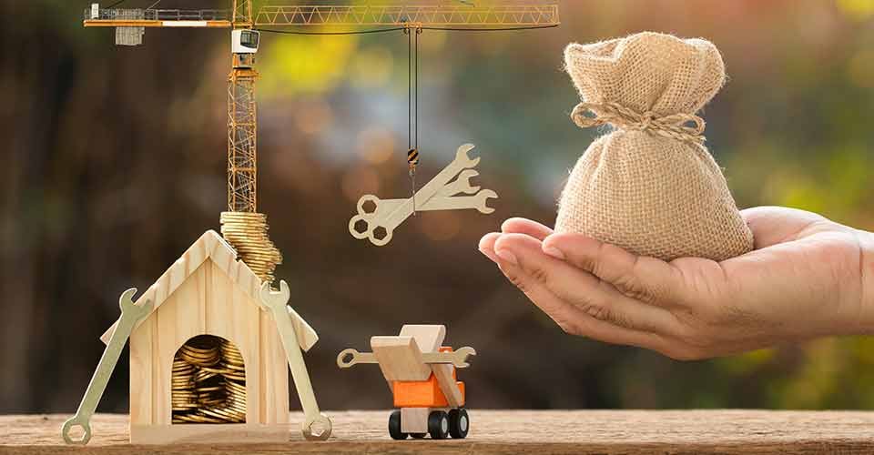 A hand hold money bag and construction equipment for home renovation