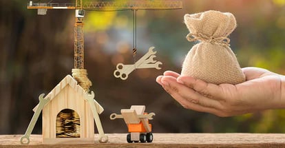 A hand hold money bag and construction equipment for home renovation