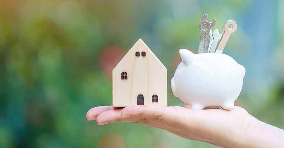 A hand hold piggy bank with wrench tools for renovation and model house