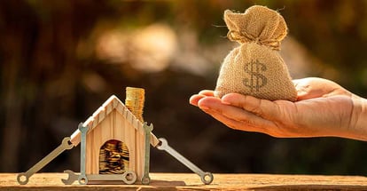 A hand holding money bag for home renovation