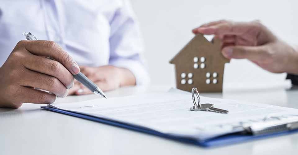 A home buyer signing contract to buy house