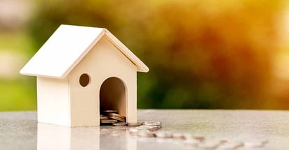 A home model and coins on the table