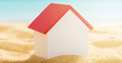 A house model on sandy beach