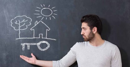 A man in front of chalkboard with house key