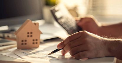 A person calculating a down payment for home purchase