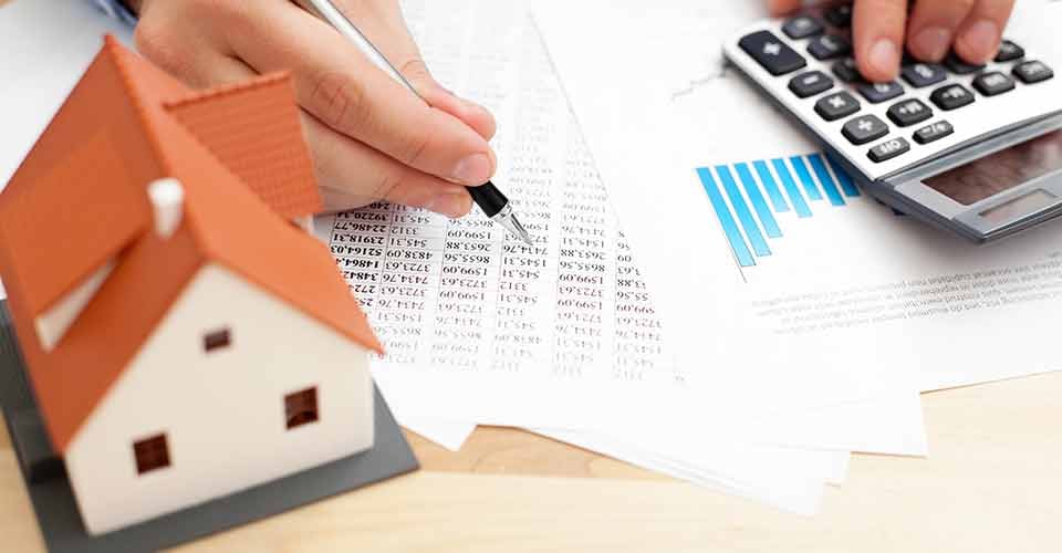 A person calculating monthly home payment