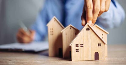 A person choosing a wood house model for investment