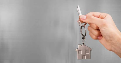 A person holding a house key