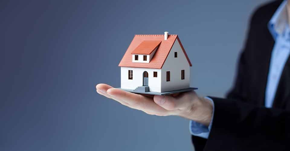A person holding home model