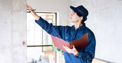 A person inspecting a house