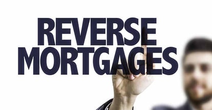 A person pointing at Reverse Mortgages text