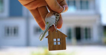 A person shows the key for new home