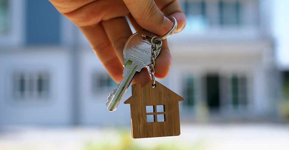 A person shows the key for new home