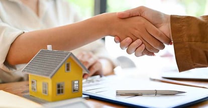 A real estate agent shaking hands with home buyer