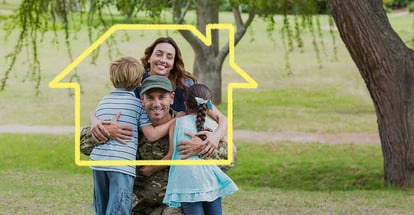 A soldier hugging his family outside home