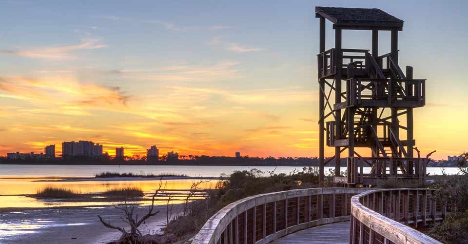 A wildlife observation tower silhouetted against a Perdido Key sunset in Big Lagoon State Park near Pensacola Florida