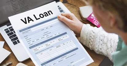 A woman looking at VA Home Loan application form