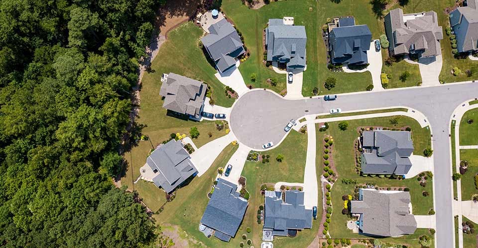 Aerial view of residential houses near road in small town in florida