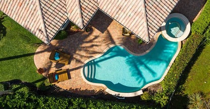 Aerial view of the backyard of a luxurious house with a swimming pool