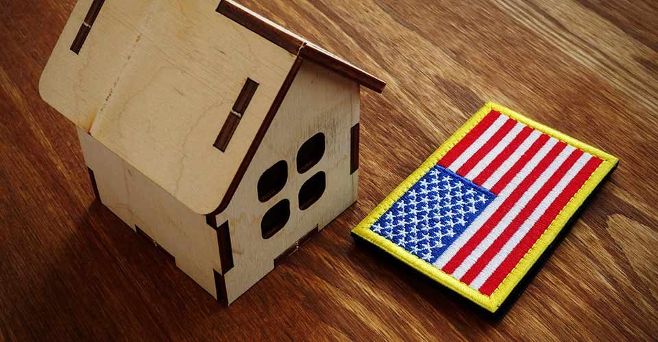 American flag and small modal house