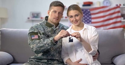 American soldier and his wife holding new house key