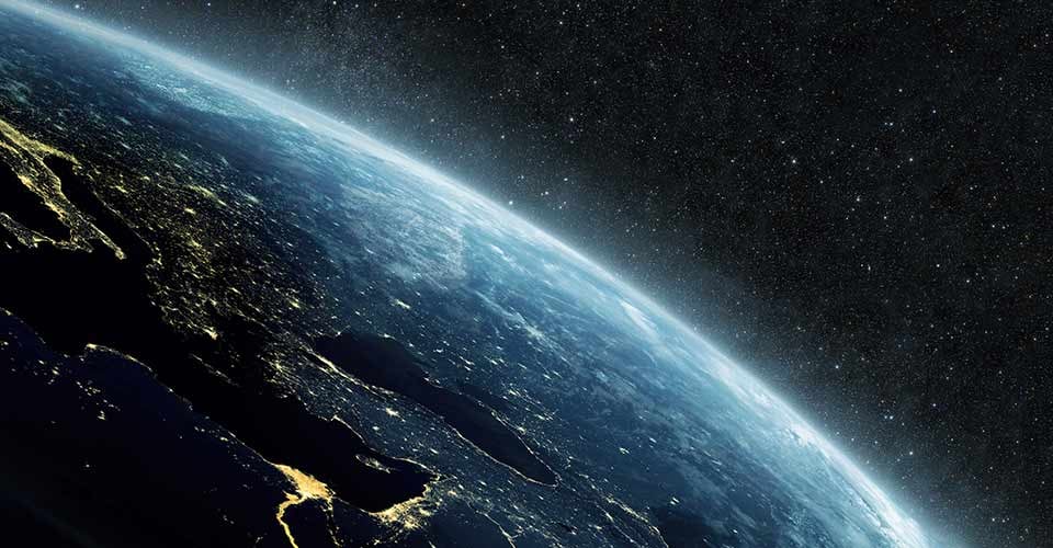 Beautiful blue planet earth with yellow city lights on the starry background in outer space