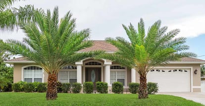 Beautiful concrete block and stucco home in the countryside with palm trees in Florida