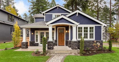 Beautiful exterior of newly built luxury home with green grass