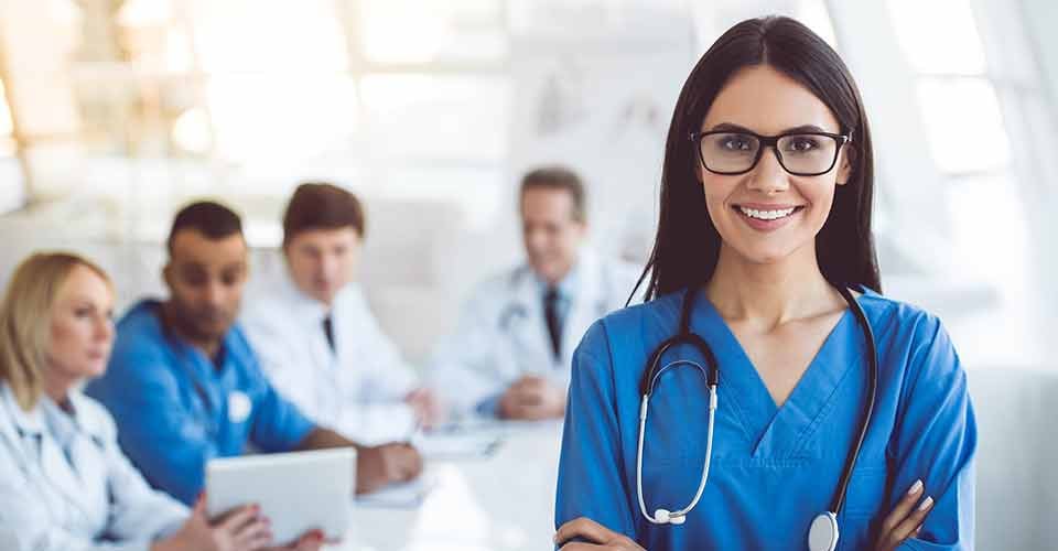 Beautiful young female nurse looking at camera and smiling