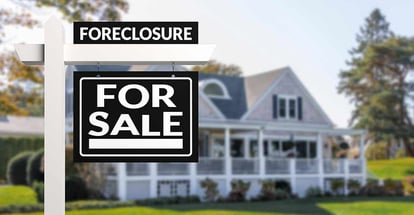 Black Foreclosure Home For Sale Real Estate Sign in front of a house