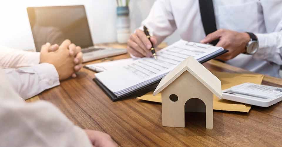 Buyer signing a contract to buy new home