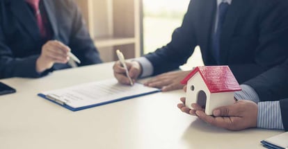 Buyer signing a house purchase contract