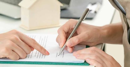 Buyer signs home purchase document