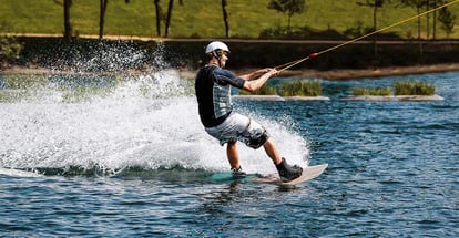 Cable wakeboard with a man on it who got pulled by rope over lake