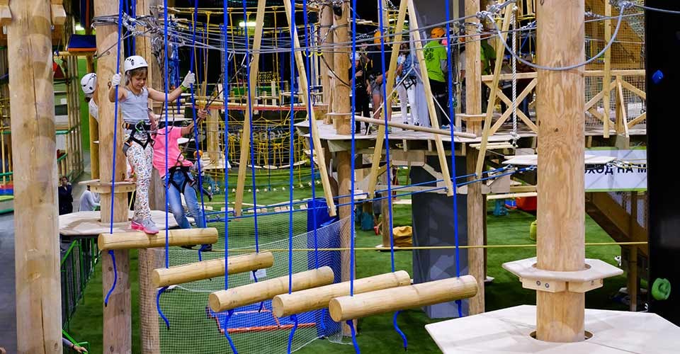 Children attend indoor adventure climbing park at day time