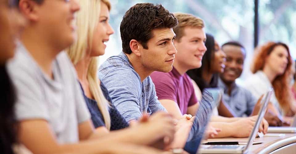 Class of University Students Using Laptops In Lecture