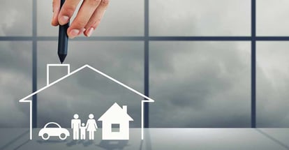 Close up of human hand drawing happy family and real estate