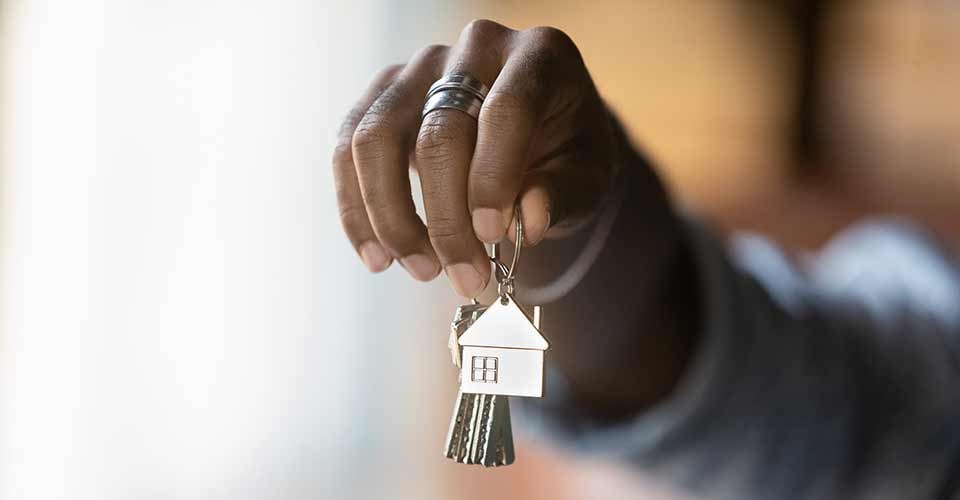Close up of young african american man hand hold bunch of keys