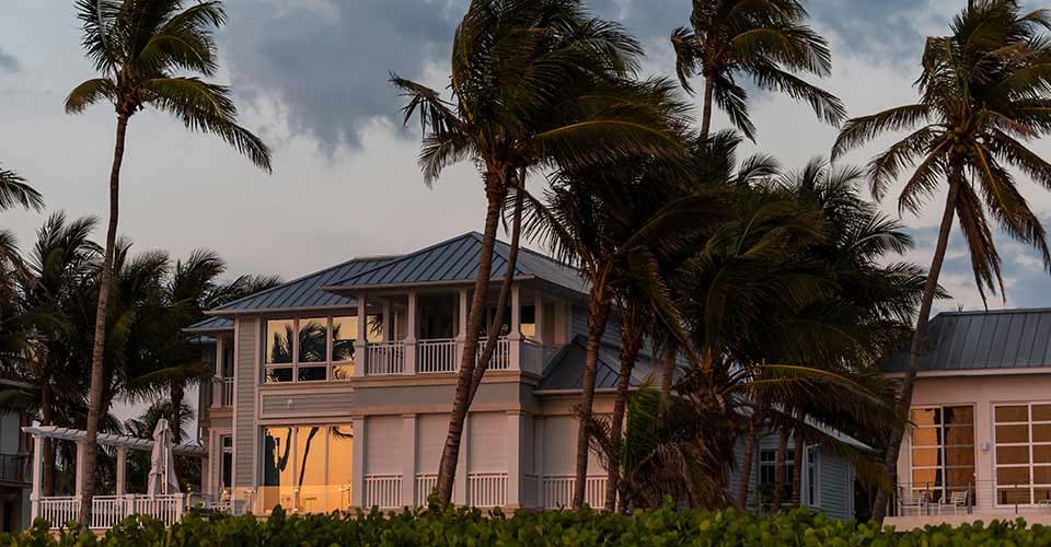 Coast house beachfront waterfront home during evening sunset in Florida