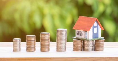 Coin stack with house model on top