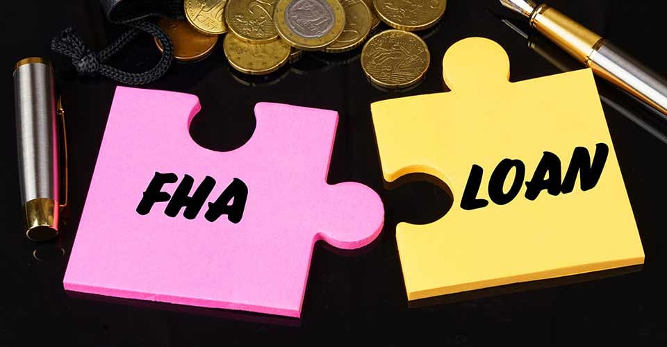 Coins are scattered on the black surface and puzzles with FHA loan written
