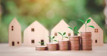Coins stack and model houses for investment property