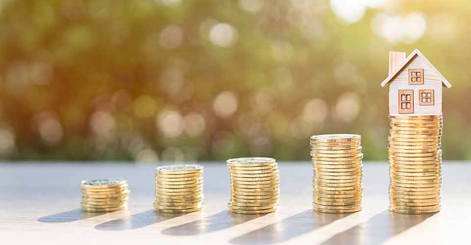Coins stack to invest in real estate